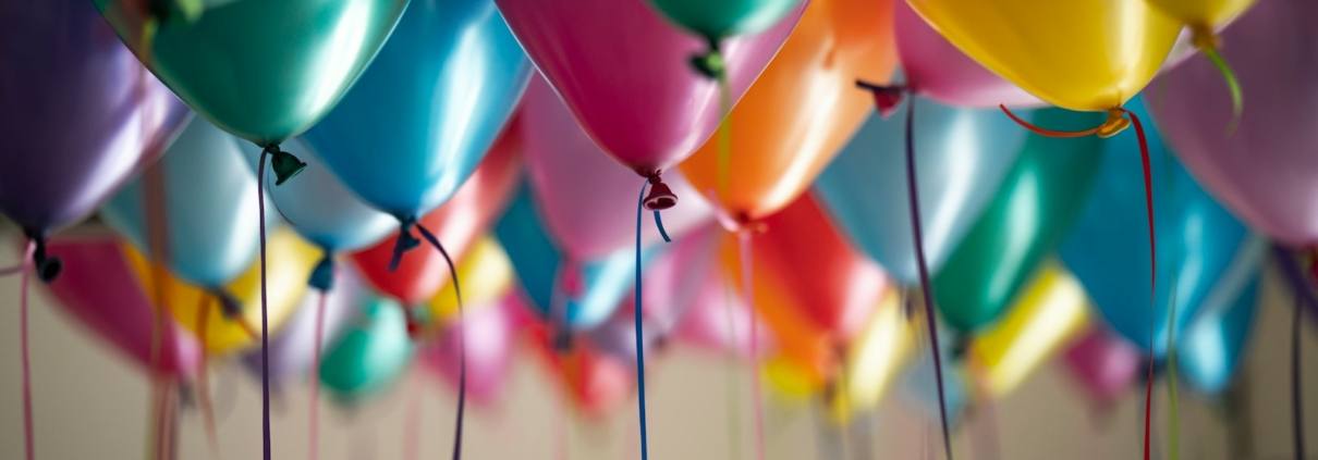 selective focus photography of assorted-color balloons